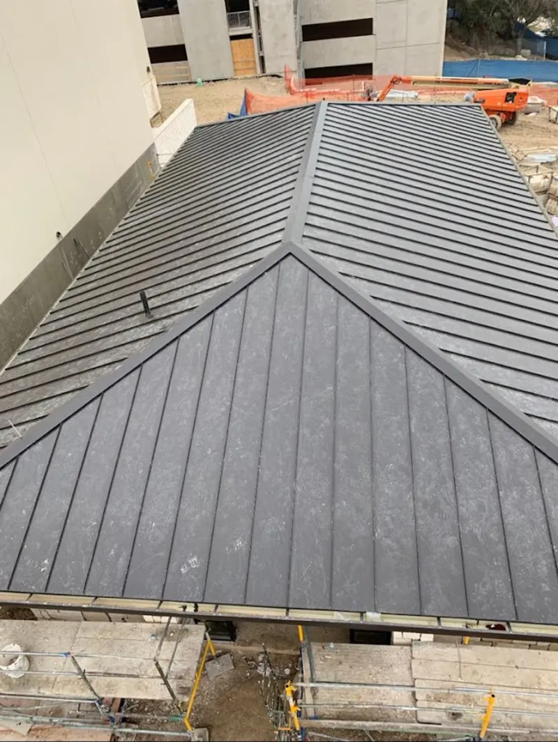 Commercial metal roof construction with crane equipment in Ocean Pines